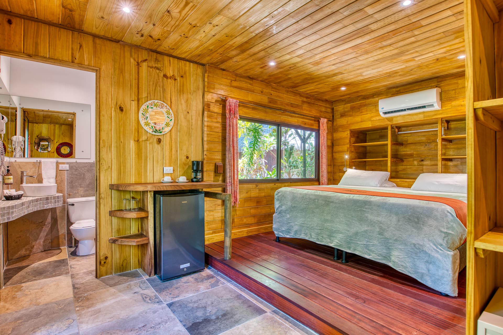 Cabina Room Interior with king bed, beautifully finished wood paneling and built-in shelves